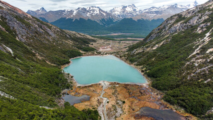 Aerial view of Laguna Esmeralda surrounded by mountains and peat bogs, Ushuaia, Patagonia, Argentina.