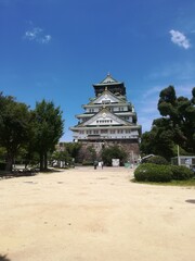 Iconic Osaka Castle Main Tower under a clear blue summer sky