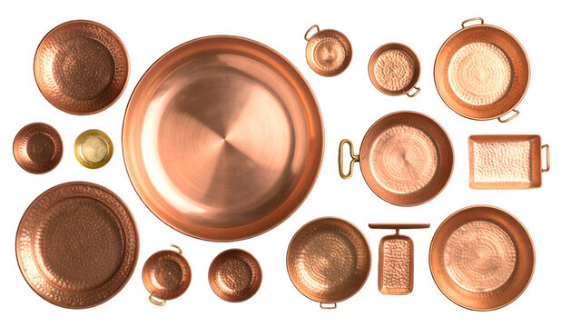 Copper cookware assortment from overhead against black, showing different shapes and textures