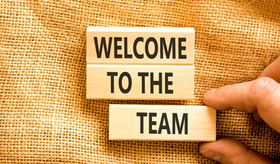 Support, help welcome to the team symbol. Concept words Welcome to the team on beautiful wooden blocks. Beautiful canvas background. Businessman's hand. Business welcome to team concept. Copy space.