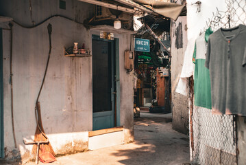 Small building with a blue door and a sign on the door.