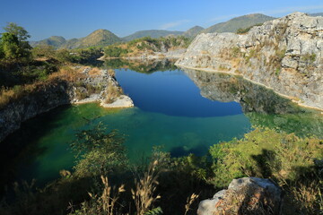 Blue Lagoon ,a large emerald-blue pond surrounded by limestone mountains. It is 70 meters deep and was created by releasing water after the stone mill stopped  mining. 
Phu Pha Man ,Khon Kaen,THAILAND