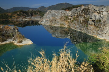 Blue Lagoon ,a large emerald-blue pond surrounded by limestone mountains. It is 70 meters deep and was created by releasing water after the stone mill stopped  mining. 
Phu Pha Man ,Khon Kaen,THAILAND