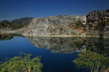 Blue Lagoon ,a large emerald-blue pond surrounded by limestone mountains. It is 70 meters deep and was created by releasing water after the stone mill stopped  mining. 
Phu Pha Man ,Khon Kaen,THAILAND