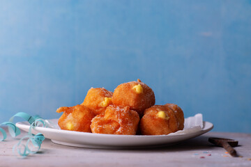 Carnival brighelle or fried cream puffs with custard