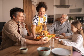 Family enjoying roasted chicken holiday meal together