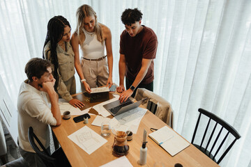 Young professionals collaborating on design ideas during a team meeting at the office