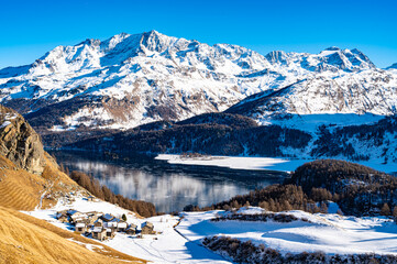 Panoramic view of the Engadine, Lake Sils, and the village of Grevasalvas in winter.