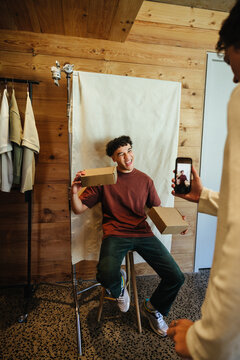 Young content creator filming for social media marketing in a casual studio setup