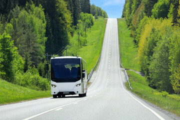 Highway landscape with a white bus traveling through beautiful rural scenery.  Copy space.  © Taina Sohlman
