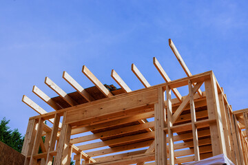 Workers build wooden frame structure with beams under assembly together new house