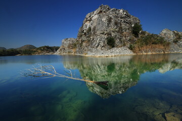 Blue Lagoon ,a large emerald-blue pond surrounded by limestone mountains. It is 70 meters deep and was created by releasing water after the stone mill stopped  mining. 
Phu Pha Man ,Khon Kaen,THAILAND