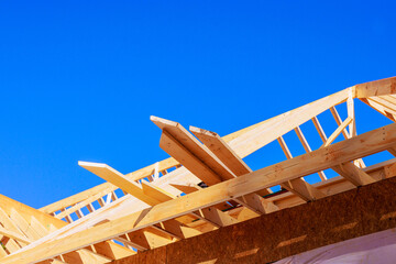 Wooden beams are positioned on building site, framework studs construction progress under beams joist