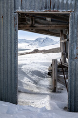 View through a derelict cabin in Camp Mansfield, New London,. This mining settlement in Konsfjorden, Svalbard, was established to mine marble, but abandoned over 100 years ago.