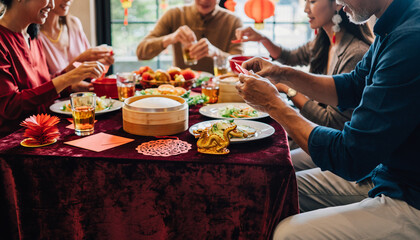 Family gathering around a festive table with food and decorations during a celebration