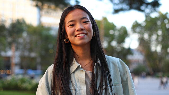 Asian american woman student smiling outdoors