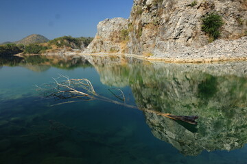 Blue Lagoon ,a large emerald-blue pond surrounded by limestone mountains. It is 70 meters deep and was created by releasing water after the stone mill stopped  mining. 
Phu Pha Man ,Khon Kaen,THAILAND