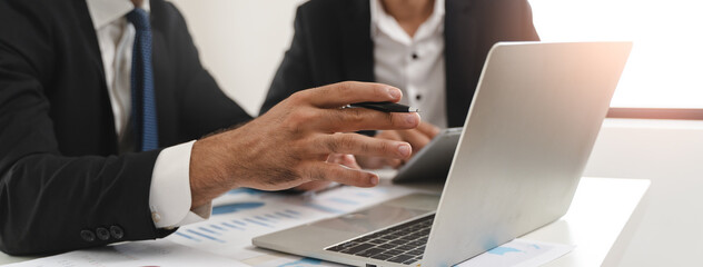 Naklejka premium financial advisory services. Asian advisor showing plan of investment to clients in the consultancy office.