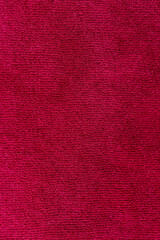Fototapeta premium Soft burgundy velour material with short pile, fabric texture