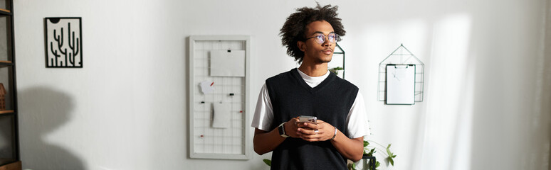 Charming young African American man enjoys a peaceful moment in his stylish modern living space