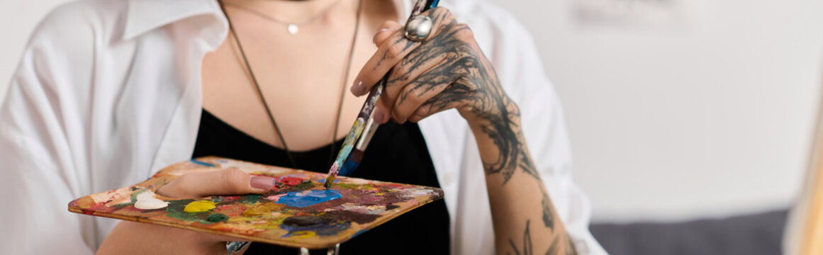 Creative young woman enjoys painting at home during afternoon light and comfort