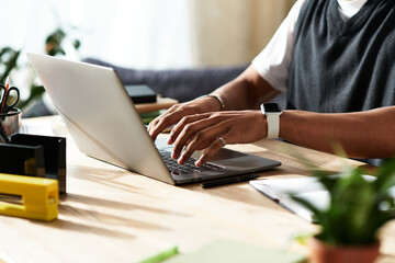 Young African American man working from his cozy modern home, enjoying a productive day