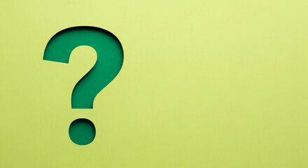 Green question mark shape cut on light yellow paper, layered, representing inquiry, curiosity, and problem solving, inviting interaction or discussion