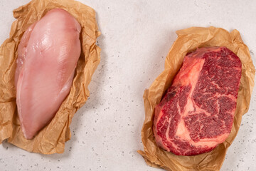 Different types of meat displayed on parchment paper for cooking preparation in kitchen