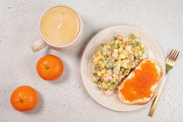Russian breakfast on January 1st. Olivier salad, toast with butter and red caviar, and coffee.