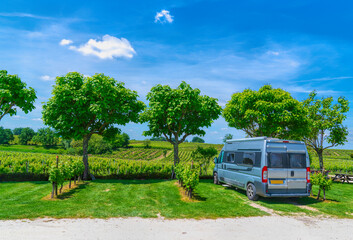 Obraz premium Campervan Motorhome Parked by French Vineyard on a Sunny Summer Day