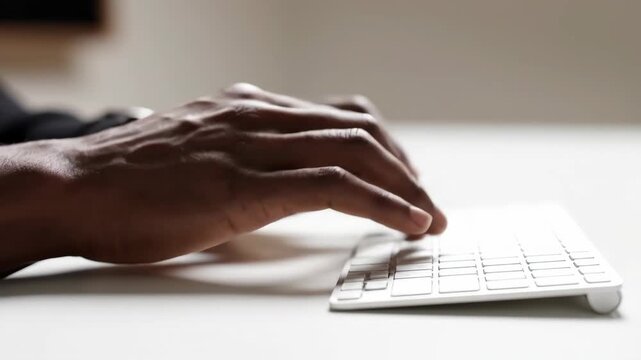 Fingers move effortlessly across a pristine keyboard in a bright and inviting workspace, capturing the essence of creativity and innovation in a vibrant digital landscape.