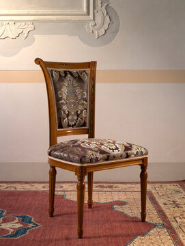 Still life of a classic style chair, with seat and back in decorated fabric