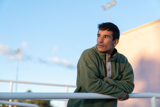 Young adult man looking away, contemplating future outdoors