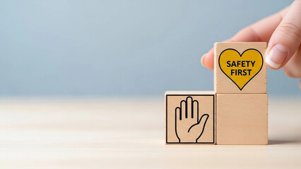 Hand Placing Wooden Block with "Safety First" Sign: Concept of Workplace Safety, Occupational Protection, and Prevention Awareness