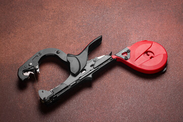 tapener. Close-up of grape vine tying tape. grape tying tool