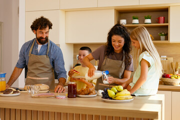 Happy Family Preparing Breakfast Together In Kitchen