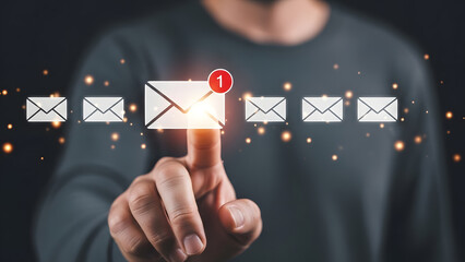 Man pressing glowing email notification icon on virtual screen | Digital communication management and secure electronic correspondence access | Business person checking new message alerts and online i