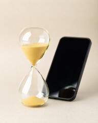 Hourglass on wooden blocks spelling DETOX with a heart symbol. A conceptual image for digital detox, mental health, self-care, and loving yourself by disconnecting from technology distractions.