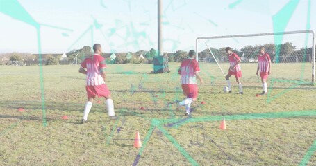 Dribbling four players in red jerseys training near goal on pitch with ball, cones, teal overlay