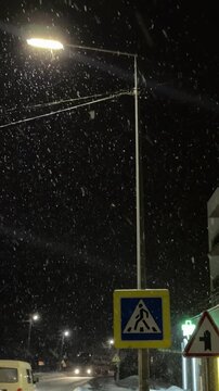 Lviv. Ukraine. 01.12.2026.
A captivating shot of heavy, dense snowflakes falling rapidly at night. The snow is brightly lit by the sharp, concentrated light of a street lamp