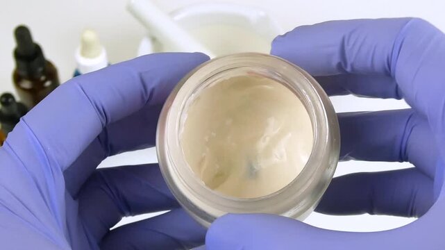 Laboratory scientist preparing a cream formulation