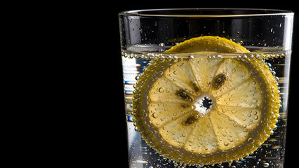 A refreshing glass of lemon water with bubbles