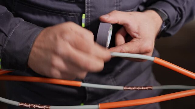 Technician Skillfully Applies Insulation Tape Around High Voltage Connector For Durability And Safety