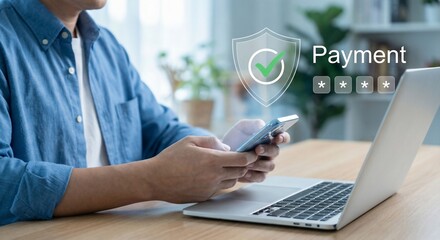 Man making online payment on laptop with secure mobile transaction.