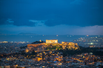 Naklejka premium Illuminated Acropolis of Athens at dusk with clouds