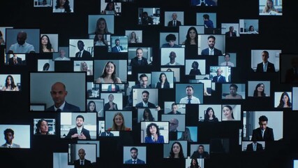 Business professionals participating in large scale virtual conference. Diverse corporate team members appearing on multiple digital screens during remote video call. Panning wide shot. - Powered by Adobe