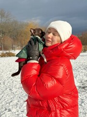Woman in Red Jacket Hugging Chihuahua in Winter