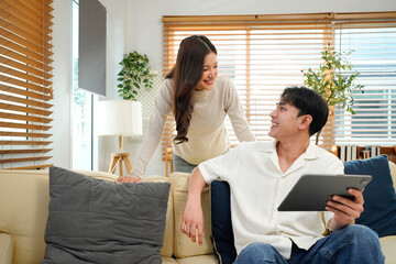 Laughing, tablet or happy couple on sofa to relax on social media for love or comfort on weekend in home. Mobile app, notification and people with smile on couch for funny joke