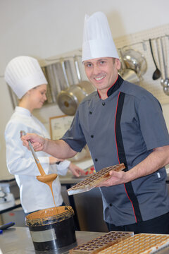 portrait of male chef using ladel