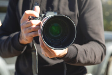 Fototapeta premium Man taking picture by professional camera in outdoor.